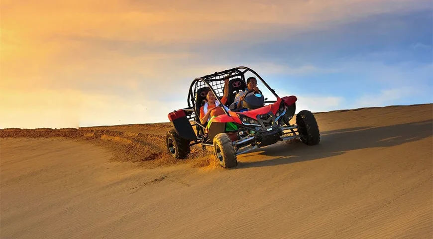 Scenic buggy ride in Dubai with a stunning sunset view.